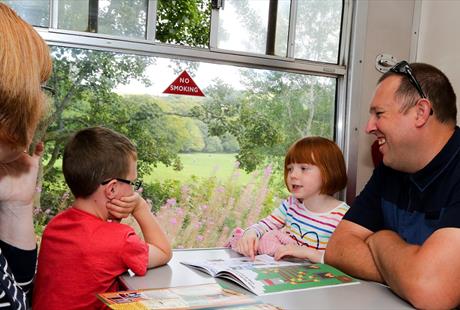 Family sat on a train at East Lancashire Railway
